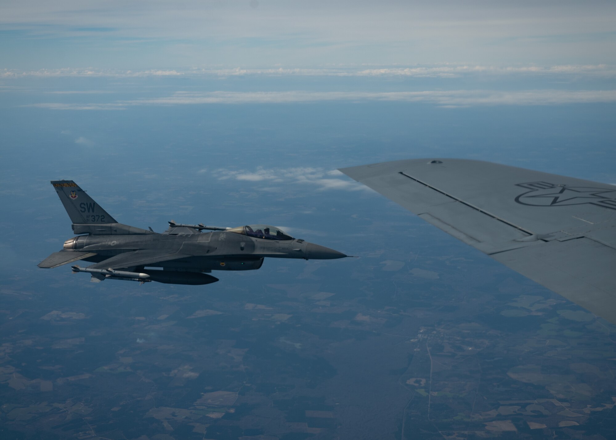 F-16C Fighting Falcon flies alongside KC-135