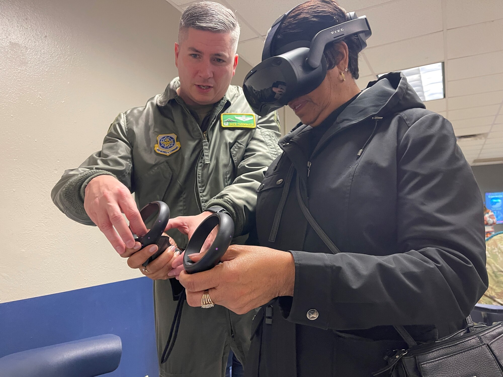 U.S. Air Force Col. David Fazenbaker, 62d Airlift Wing commander, guides Mary Moss, City of Lakewood deputy mayor and 62d AW Honorary Commander, on how to use virtual reality equipment during the McChord Civic Leader Tour at Sheppard Air Force Base, Texas, Feb. 7, 2013. The goal of the Civic Leader Tour was to educate local civic leaders on the way the Air Force trains America’s Airlift Wing Mobility Warfighters and show the different Air Force technical school training programs for C-17 Globemaster III pilots, maintainers, and loadmasters. (U.S. Air Force photo by Master Sgt. Julius Delos Reyes)