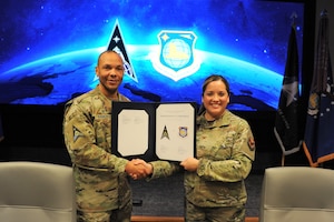 Col. Ariel G. Batungbacal, National Air and Space Intelligence Center commander, and Marqus D. Randall, National Space Intelligence Center commander, pose for a photo following a Memorandum of Agreement signing ceremony at Wright-Patterson Air Force Base, Ohio, Feb. 10, 2023. The MOA outlines various roles and responsibilities, and formalizes an already collaborative partnership between the two Centers.