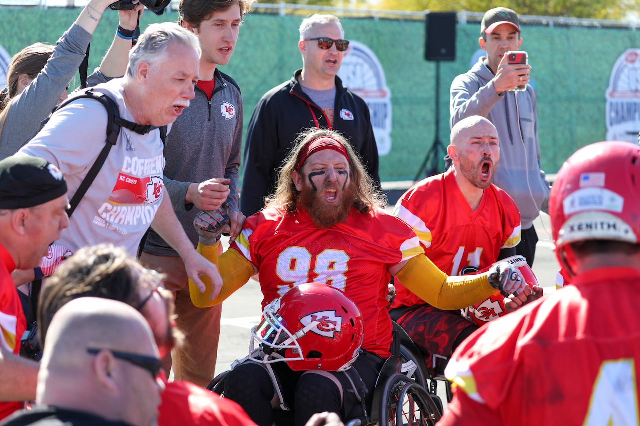 Several players in wheelchairs and others shout during a game.