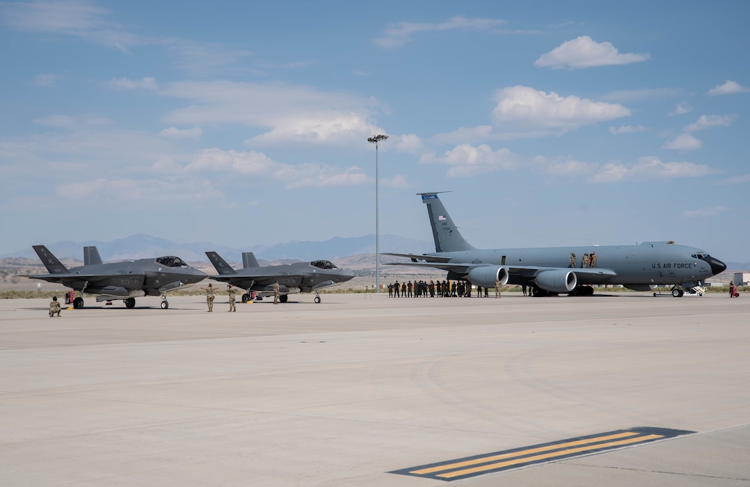One KC-135R and two F-35 aircraft stage on airstrip