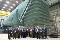 Naval Surface Warfare Center, Carderock Division employees, University of Memphis staff members and congressional staffers pose at the base of the Large Cavitation Channel (LCC) at Carderock’s Memphis Detachment in Tennessee on Feb. 6, where they kicked off a partnership to develop an Unmanned Aerial Vehicles Environment Degradation Lab and do Cavitation Erosion Research. (U.S. Navy photo by Todd Hurley)