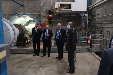 Matthew Brantz (second to left), Site Director of Naval Surface Warfare Center, Carderock Division’s Memphis Detachment, shows University of Memphis (UofM) President Dr. Bill Hardgrave (left), Dr. Eddie Jacobs (second to right), professor of electrical and computer engineering, as well as Wiley Henry, a staff member for U.S. Representative Steve Cohen, the motor and shaft of the Large Cavitation Channel (LCC) at Carderock’s Memphis Detachment in Tennessee during a tour on Feb. 6. (U.S. Navy photo by Todd Hurley)