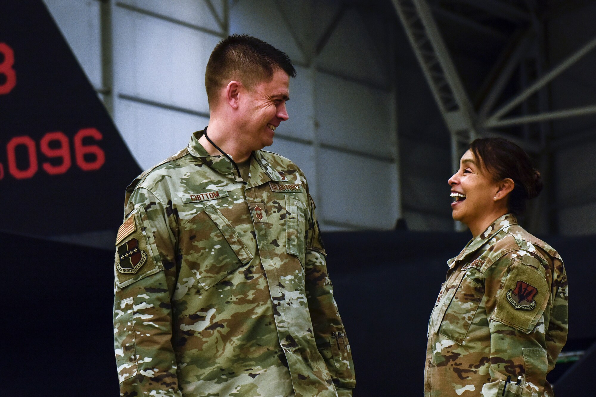 U.S. Air Force Chief Master Sgt. Esmeralda Chittom, 9th Operations Group senior enlisted leader, and U.S. Air Chief Master Sgt. Bobby Chittom, 9th Maintenance Group senior enlisted leader pose inside a hanger Feb. 14, 2023, at Beale Air Force Base, Calif.