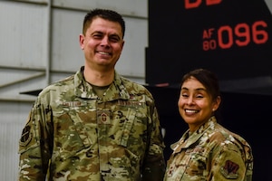 U.S. Air Force Chief Master Sgt. Esmeralda Chittom, 9th Operations Group senior enlisted leader, and U.S. Air Chief Master Sgt. Bobby Chittom, 9th Maintenance Group senior enlisted leader pose inside a hanger Feb. 14, 2023, at Beale Air Force Base, Calif.