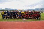 Sailors and Marines, assigned to amphibious transport dock ship USS John P. Murtha (LPD 26), pose for a photo after a game of football with members of the Timor-Leste Defense Force (F-FDTL) during the opening ceremony of Cooperation Afloat Readiness and Training (CARAT)/Marine Exercise (MAREX) 2023 in Dili, Feb. 10, 2023. CARAT/MAREX Timor-Leste is a bilateral exercise between Timor-Leste and the United States designed to promote regional security cooperation, maintain and strengthen maritime partnerships, and enhance maritime interoperability. In its 28th year, the CARAT series is comprised of multinational exercises, designed to enhance U.S. and partner forces’ abilities to operate together in response to traditional and non-traditional maritime security challenges in the Indo-Pacific region. (U.S. Navy photo by Mass Communication Specialist 2nd Class Joshua Samoluk)