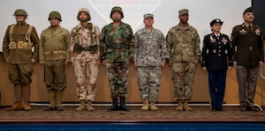 U.S. Army 1st Infantry Division noncommissioned officers participate in the ‘Big Red One Year of the NCO’ opening ceremony, Feb. 16, 2022, at the division’s Victory Hall headquarters. NCO’s of each Army noncommissioned officer rank dressed in periodic Army uniforms to highlight the longevity of the NCO Corps, since its establishment over 200 years ago. (U.S. Army photo by Sgt. Alvin Conley) (Sgt. Alvin Conley)