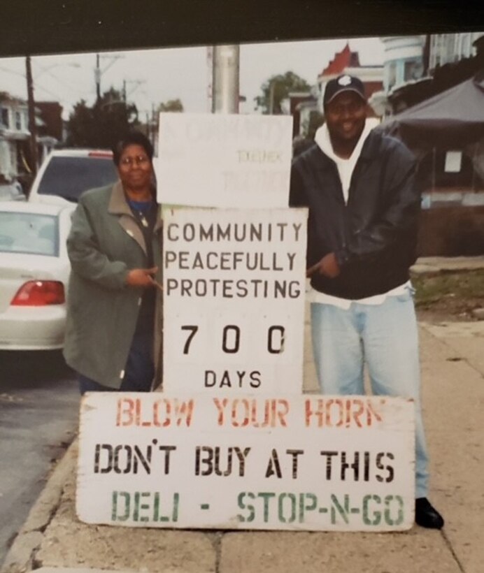 Joyce Lambert, left, and a fellow community member pose for a photo while protesting at the corner of 55th and Larchwood Avenue in Philadelphia in 2002.