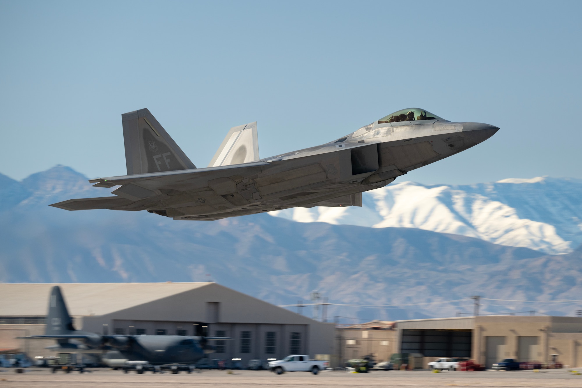 An F-22 Raptor assigned to the 94th Fighter Squadron, Joint Base Langley-Eustis, Virginia, takes off prior to the start of Red Flag 23-1 at Nellis Air Force Base, Nevada, Jan. 24, 2023. The 414th Combat Training Squadron conducts Red Flag exercises to provide aircrews the experience of multiple, intensive air combat sorties in the safety of a training environment. (U.S. Air Force photo by William R. Lewis)