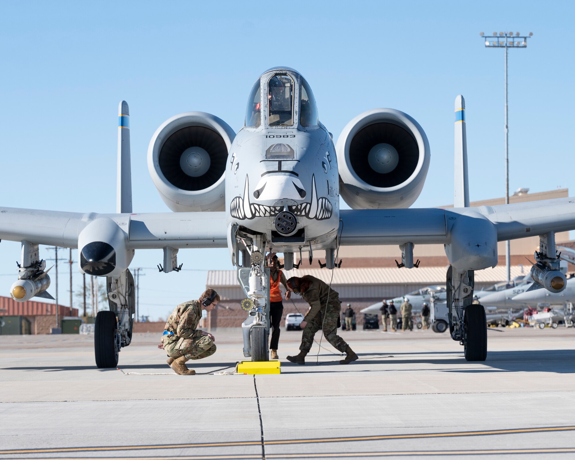 U.S. Air Force Senior Airman Sydney Woo, right, 354th Fighter Generation Squadron weapons specialist, Airman First Class Tre Washington, center, 355th Equipment Maintenance Squadron AR crew chief, and Airman Kenton McCroskey, 354th Fighter Generation Squadron weapons specialist, perform final checks on an A-10C Thunderbolt II before take off at Nellis Air Force Base, Nevada, Jan. 24, 2023. Red Flag provides unique training with an emphasis on Airmen and Guardians’ readiness for high-end war fighting and strategic competition. (U.S. Air Force photo by Staff Sgt. Nicholas Ross)