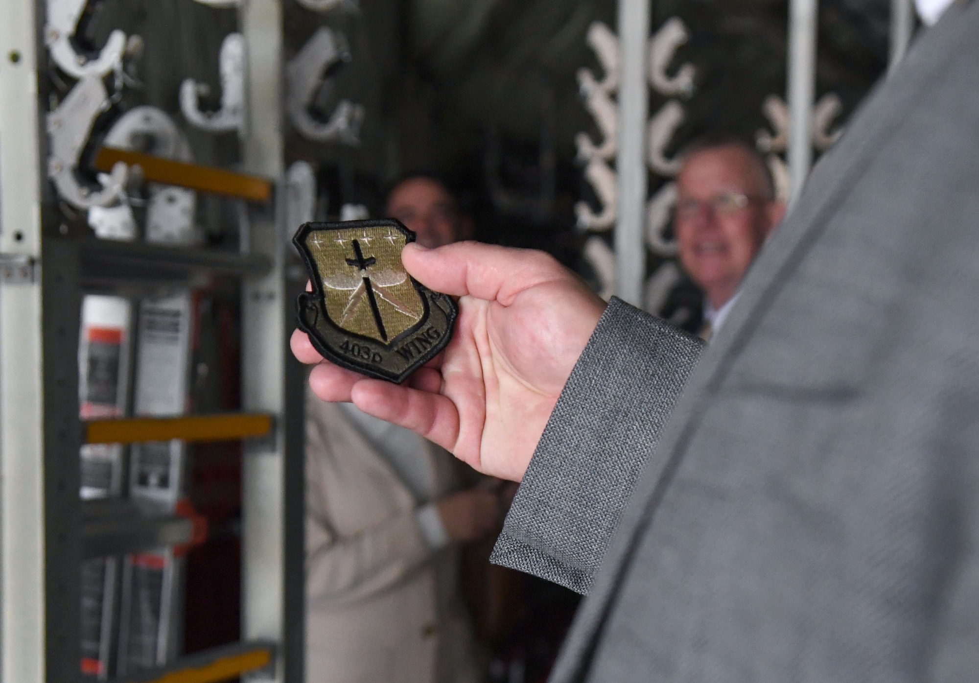 Matt Barnett, Office of Congressman Mike Ezell field representative, holds a 403rd Wing patch inside a C-130 aircraft during an immersion tour at Keesler Air Force Base, Mississippi, Feb. 15, 2023.