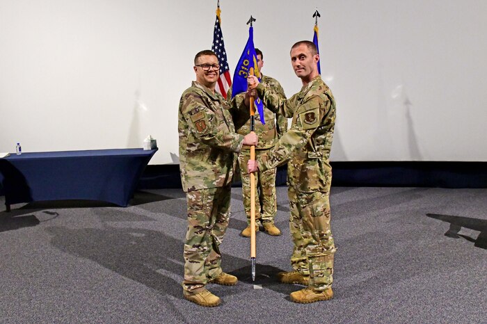 Military members holding guidon