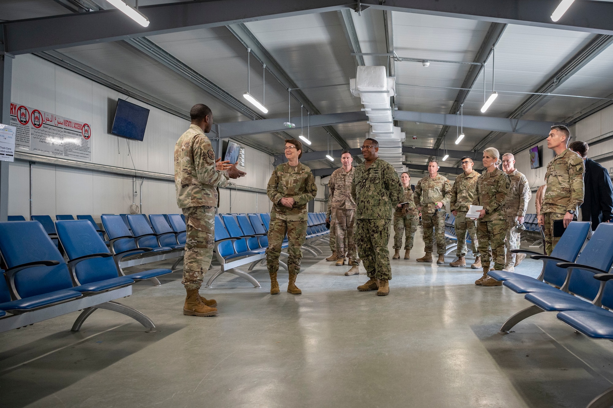 U.S. Air Force Gen. Jacqueline D. Van Ovost, U.S. Transportation Command commander, and U.S. Navy Fleet Master Chief Donald O. Myrick, USTRANSCOM senior enlisted leader, tour the passenger terminal at Cargo City, Kuwait, Feb. 10, 2023.