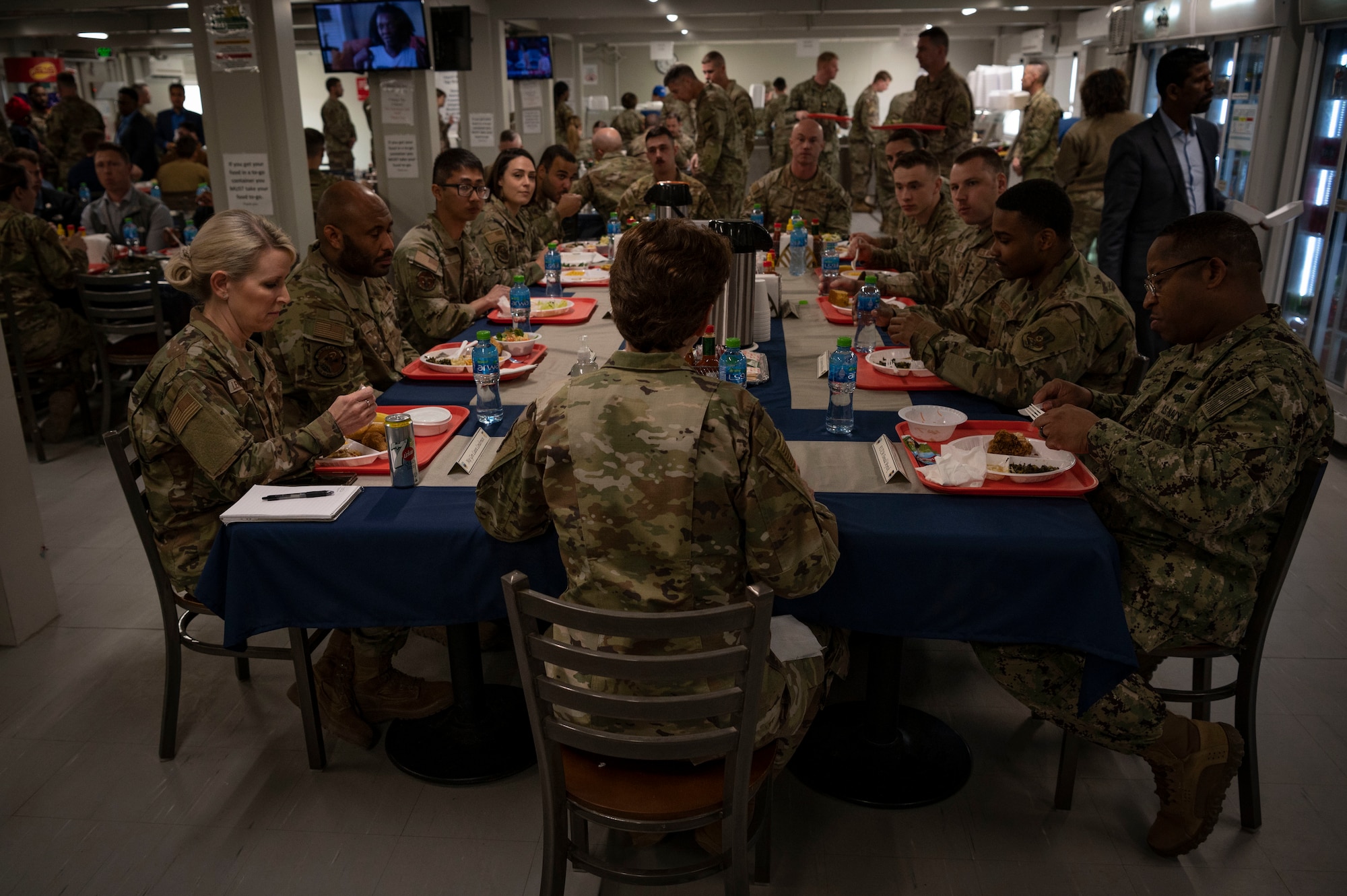 U.S. Air Force Gen. Jacqueline D. Van Ovost, U.S. Transportation Command commander, eats lunch with Airmen at Cargo City, Kuwait, Feb. 10, 2023.