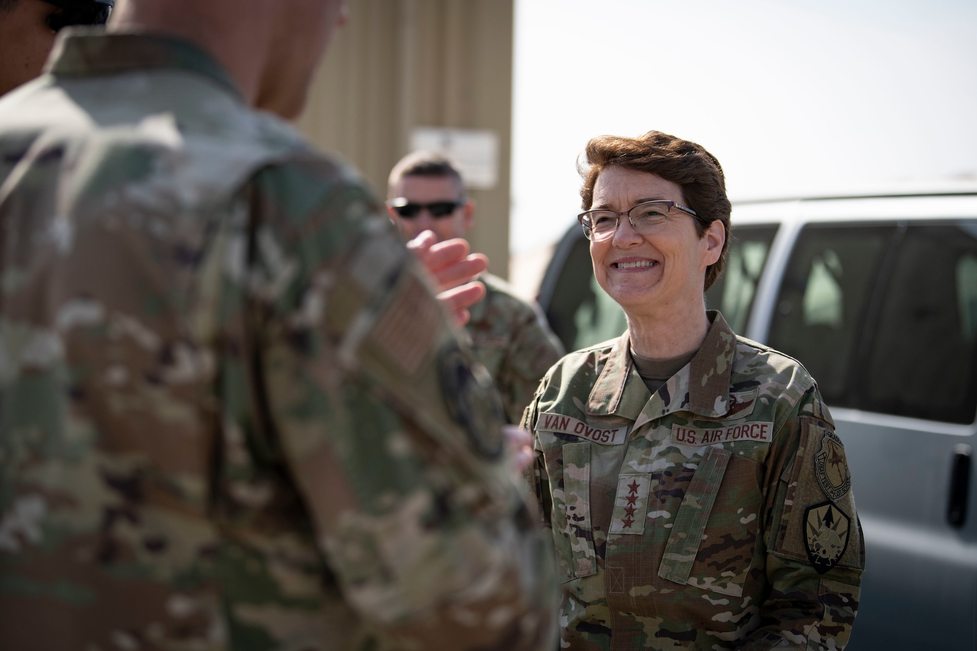 U.S. Air Force Gen. Jacqueline D. Van Ovost, U.S. Transportation Command commander, speaks with an Airman at Cargo City, Kuwait, Feb.10, 2023.