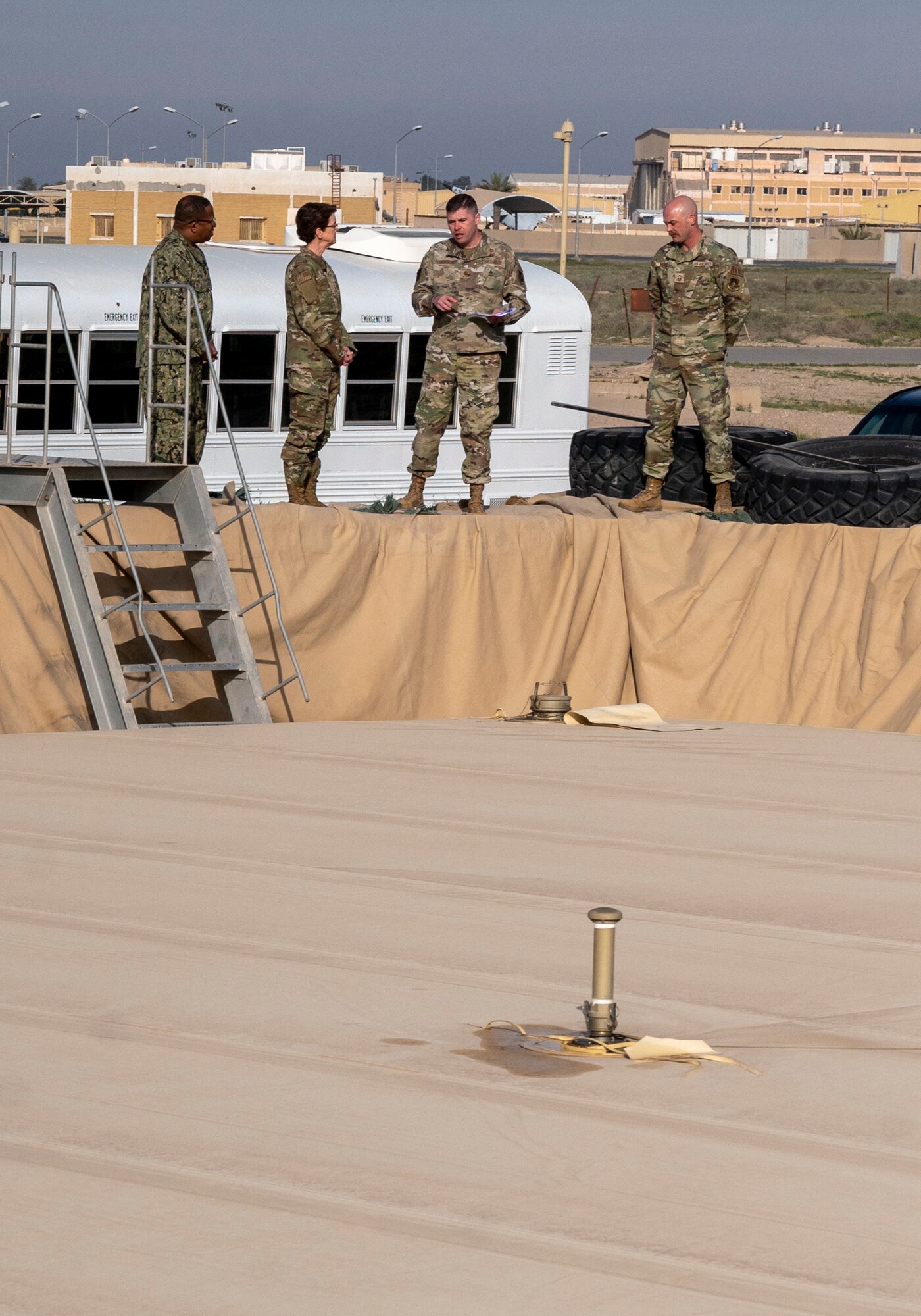 U.S. Air Force Major Shawn Cameron, 386th Expeditionary Logistics Readiness Squadron commander and Senior Master Sgt. Christopher Moore, 386th ELRS logistics readiness flight, shows the fuel farm to U.S. Air Force Gen. Jacqueline Van Ovost, U.S. Transportation Command commander, and U.S. Navy Fleet Master Chief Petty Officer Donald O. Myrick, U.S. Transportation Command senior enlisted leader, at Ali Al Salem Air Base, Kuwait, Feb. 10, 2023.