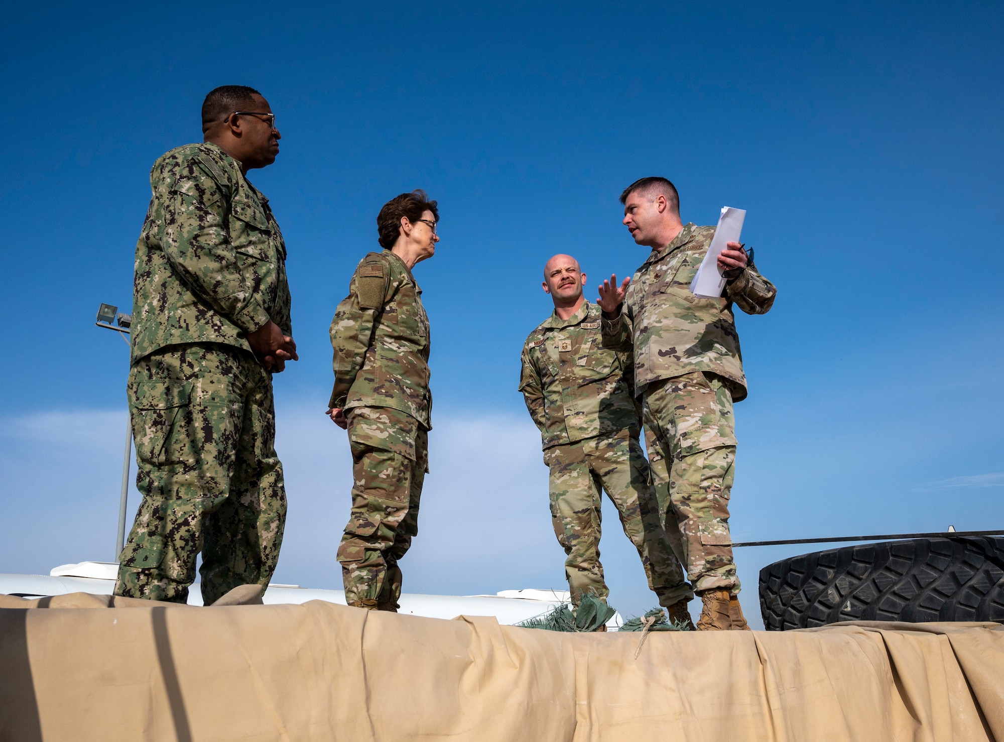 U.S. Air Force Major Shawn Cameron, 386th Expeditionary Logistics Readiness Squadron commander and U.S. Air Force Senior Master Sgt. Christopher Moore, 386th ELRS logistics readiness flight, shows the fuel farm to U.S. Air Force Gen. Jacqueline Van Ovost, U.S. Transportation Command commander, and U.S. Navy Fleet Master Chief Petty Officer Donald O. Myrick, U.S. Transportation Command senior enlisted leader, at Ali Al Salem Air Base, Kuwait, Feb. 10, 2023.
