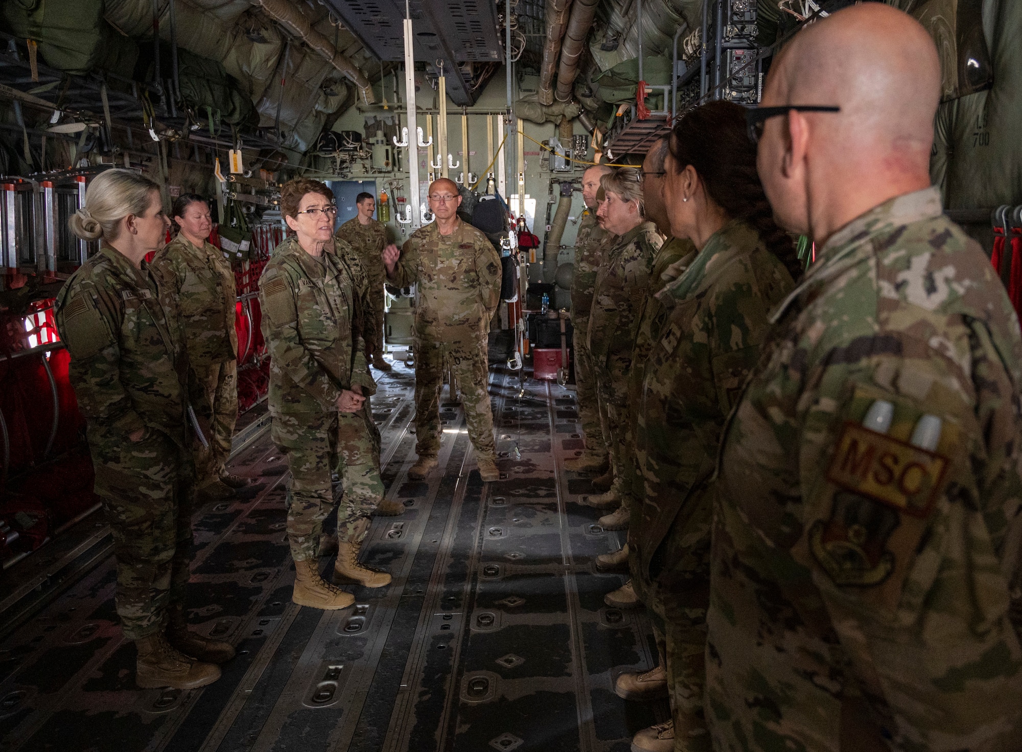 U.S. Air Force Gen. Jacqueline Van Ovost, U.S. Transportation Command commander, and U.S. Navy Fleet Master Chief Petty Officer Donald O. Myrick, U.S. Transportation Command senior enlisted leader, speak with Airmen from the 405th Expeditionary Air Evacuation Squadron at Ali Al Salem Air Base, Kuwait, Feb. 10, 2023.