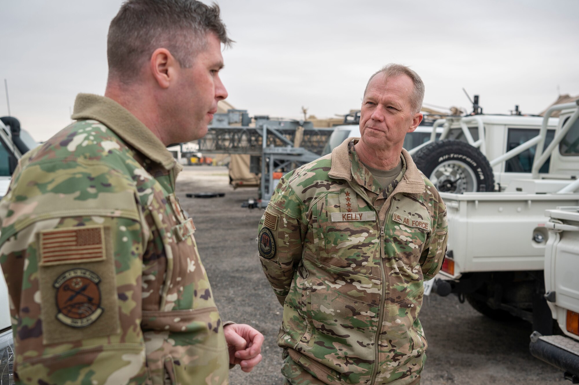 U.S. Air Force Gen. Mark Kelly, commander of Air Combat Command, learns about the cargo yard from Maj. Shawn Cameron, 386th Expeditionary Logistics Readiness Squadron commander, during a tour at Ali Al Salem Air Base, Kuwait, Feb. 15, 2023.