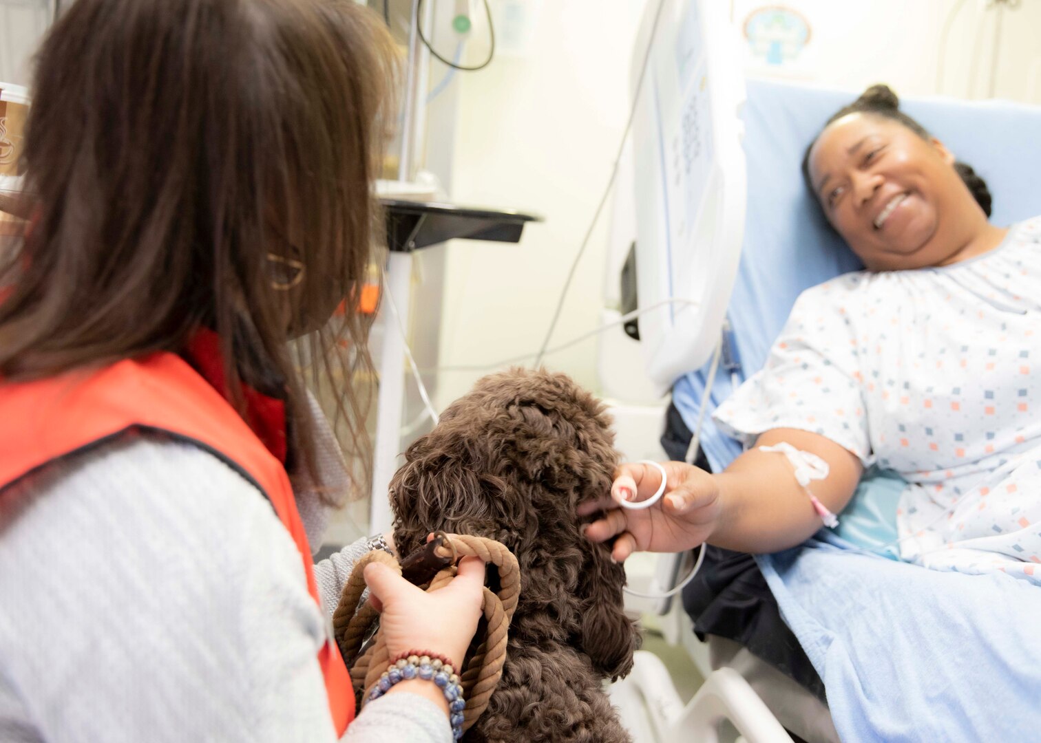 An inpatient at Landstuhl Regional Medical Center’s Medical-Surgical Ward, visit with Saif and DeDe Musa, American Red Cross volunteers, during Saif’s first day volunteering with the Landstuhl American Red Cross Pet Visitation Program, at Landstuhl Regional Medical Center, Jan. 19.