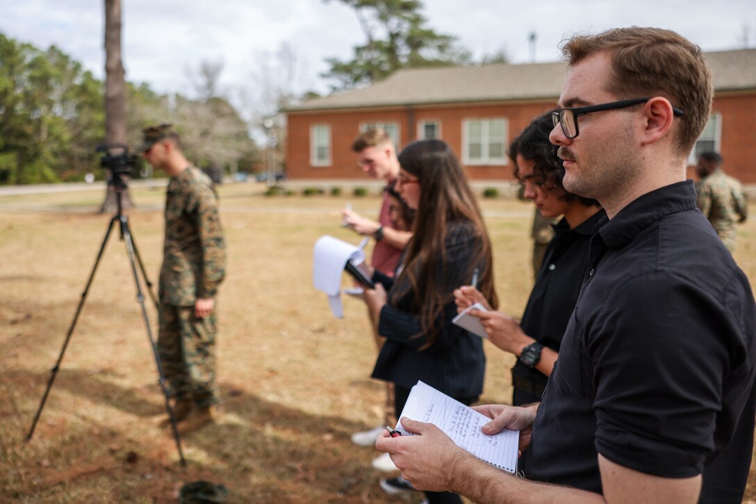 U.S. Marine Corps Lance Cpl. Dylon Grasso, a combat photographer with the Defense Media Activity participates in a training press conference with Communication Strategy and Operations Marines during Marine Expeditionary Force Exercise (MEFEX), Marine Corps Base Camp Lejeune, North Carolina, Feb. 16, 2023. II MEF is currently participating in MEFEX, a MEF-level exercise that develops command and control capabilities of the MEF and its staff in preparation for operations or contingencies. (U.S. Marine Corps photo by Sgt Nathan Mitchell)