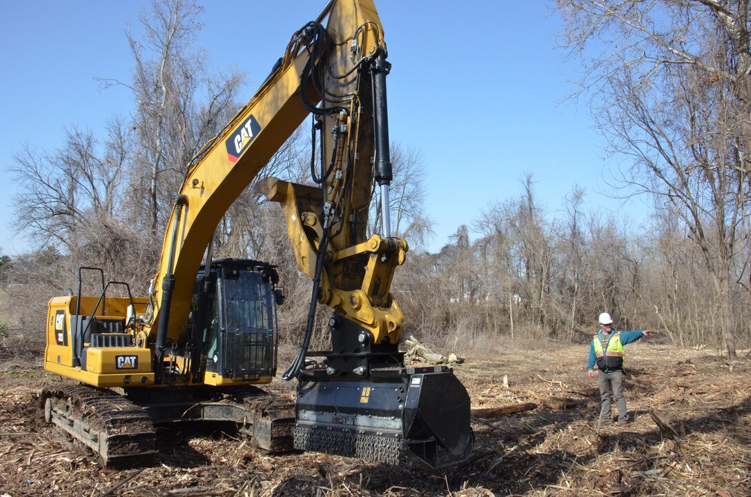 Contractors working for the U.S. Army Corps of Engineers (USACE) clear a large swath of densely-wooded brush (approx. 700-foot by 50-foot-wide area) located approximately two football fields away from Jana Elementary School in Florissant, Missouri, to allow surveyors to thoroughly analyze the topography of the area. The data collected will be used to inform the project team as they develop their plan to remediate low-level contamination that was identified at the bottom of a steep creek bank as part of ongoing remediation activities under the Formerly Utilized Sites Remedial Action Program (FUSRAP). This remediation work is scheduled to begin later this summer. In addition to advancing ongoing remediation efforts along Coldwater Creek authorized under FUSRAP, USACE performed comprehensive sampling efforts inside and outside Jana Elementary School in late 2022 that concluded from a radiological standpoint, the school is safe. USACE will continue to prioritize the health and well-being of the community, guided by data-driven decisions.  (USACE Photo by JP Rebello)