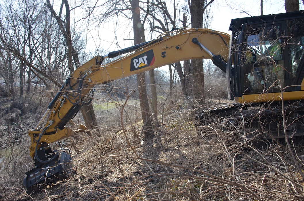 Contractors working for the U.S. Army Corps of Engineers (USACE) clear a large swath of densely-wooded brush (approx. 700-foot by 50-foot-wide area) located approximately two football fields away from Jana Elementary School in Florissant, Missouri, to allow surveyors to thoroughly analyze the topography of the area. The data collected will be used to inform the project team as they develop their plan to remediate low-level contamination that was identified at the bottom of a steep creek bank as part of ongoing remediation activities under the Formerly Utilized Sites Remedial Action Program (FUSRAP). This remediation work is scheduled to begin later this summer. In addition to advancing ongoing remediation efforts along Coldwater Creek authorized under FUSRAP, USACE performed comprehensive sampling efforts inside and outside Jana Elementary School in late 2022 that concluded from a radiological standpoint, the school is safe. USACE will continue to prioritize the health and well-being of the community, guided by data-driven decisions.  (USACE Photo by JP Rebello)