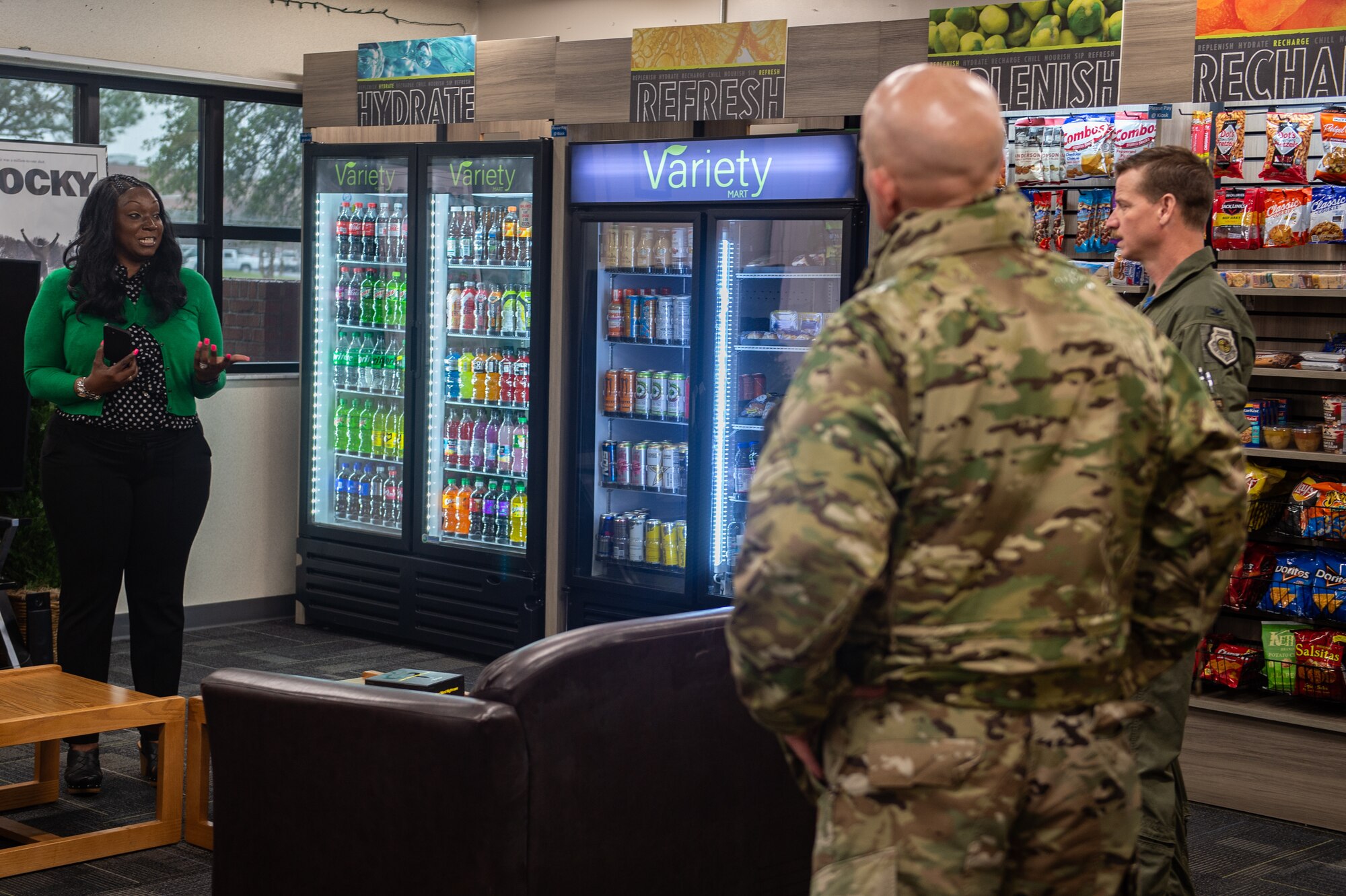 A photo of a woman speaking to Airmen.