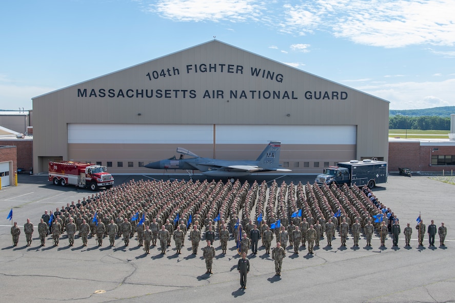 U.S. Air Force Airmen from the 104th Fighter Wing, Massachusetts Air National Guard pose for a wing group photo on the flightline June 12, 2022 at Barnes Air National Guard Base, Massachusetts. The mission of the 104FW is to prepare and deploy in support of domestic, humanitarian and combat operations anywhere in the world. (U.S. Air National Guard photo by Staff Sgt. Hanna Smith)