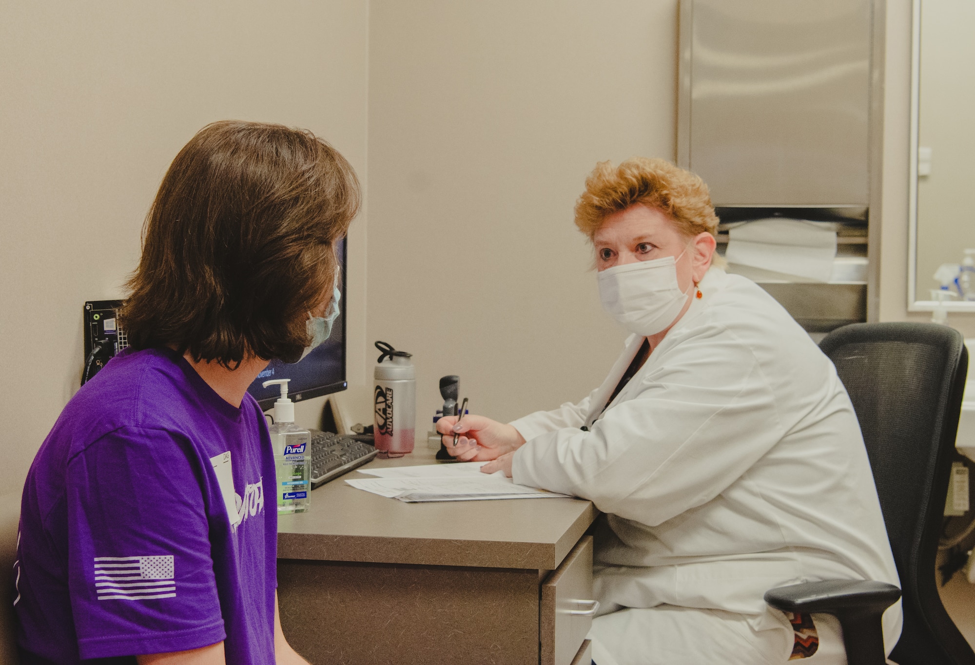 CHICAGO (November 4, 2021) Dr. Liza Pilch, a medical provider at Chicago MEPS, conducts a medical evaluation with an applicant in Chicago MEPS medical department.