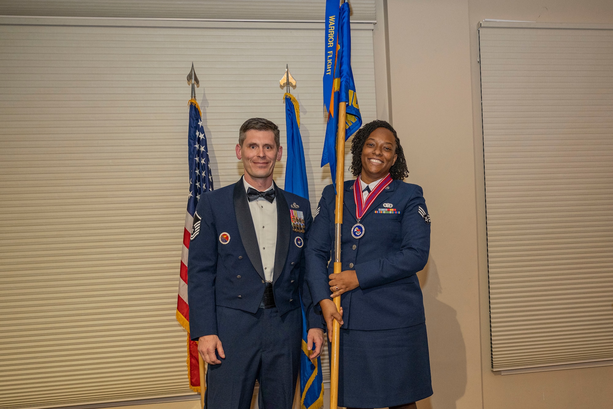 Senior Airman Shartavia Oaks, 4th Security Forces Squadron investigator, right, poses for a photo with Master Sergeant Brandin Wendt, Airman Leadership School commandant, after receiving the warrior flight award during ALS class 23-B graduation ceremony at Seymour Johnson Air Force Base, North Carolina, Feb. 9, 2023. The warrior flight award is given to the flight who scores best in the categories of dress and appearance, Air Force physical fitness tests, quiz bowl academics, commandant cup performance and individual recognitions by first sergeants and instructors.