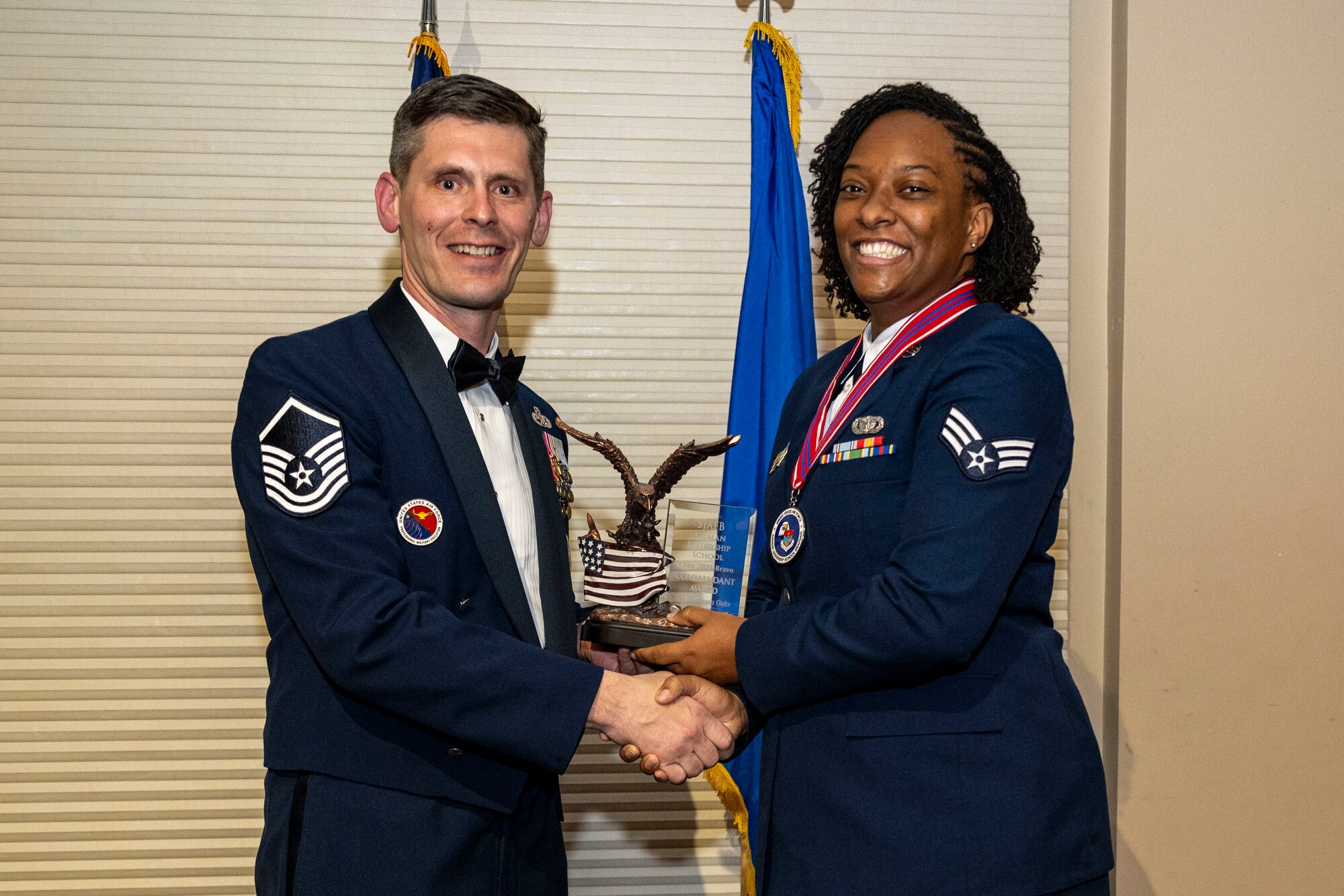 Senior Airman Shartavia Oaks, 4th Security Forces Squadron investigator, right, receives the commandant’s award from Master Sergeant Brandin Wendt, Airman Leadership School commandant, during ALS class 23-B graduation ceremony at Seymour Johnson Air Force Base, North Carolina, Feb. 9, 2023. The commandant’s award was given to the Airman in an ALS class that possesses the highest degree of character, competence and commitment.