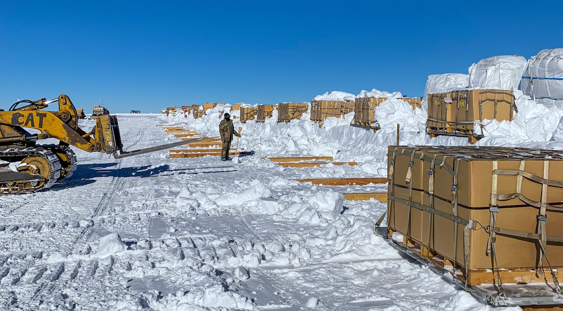 New York  Air National Guard Airmen on the South Pole retrograde cargo team work alongside contractors with the National Science Foundation to clear cargo pallets from snow banks in Antarctica Nov. 30,  2022. The team used skid steer loaders, bulldozers, shovels and brooms to dig out the pallets.