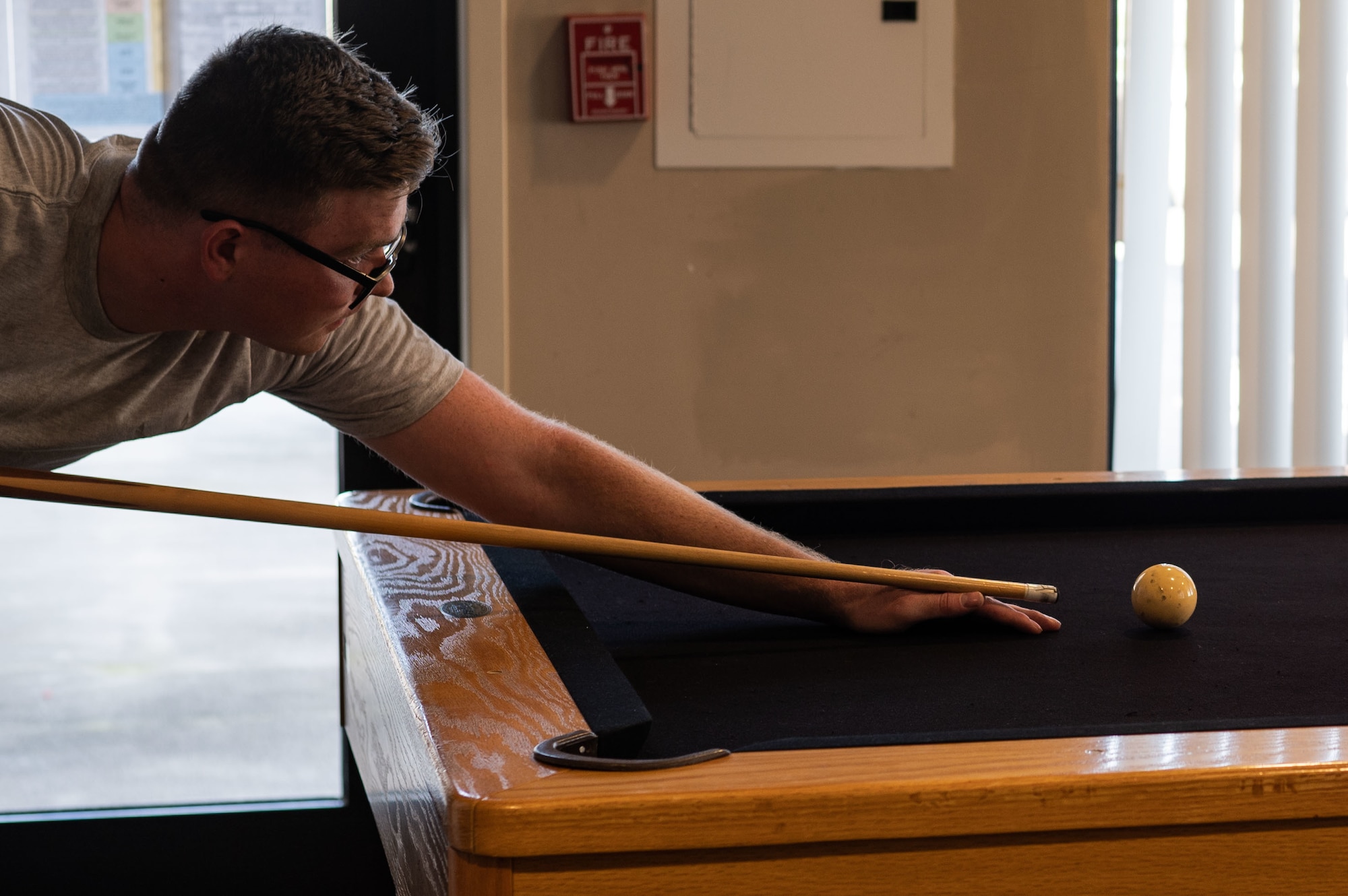 Andrews enjoys one of the newly upholstered pool tables refelted at the dormitories. (U.S. Air Force photo by Airman 1st Class Sterling Sutton)