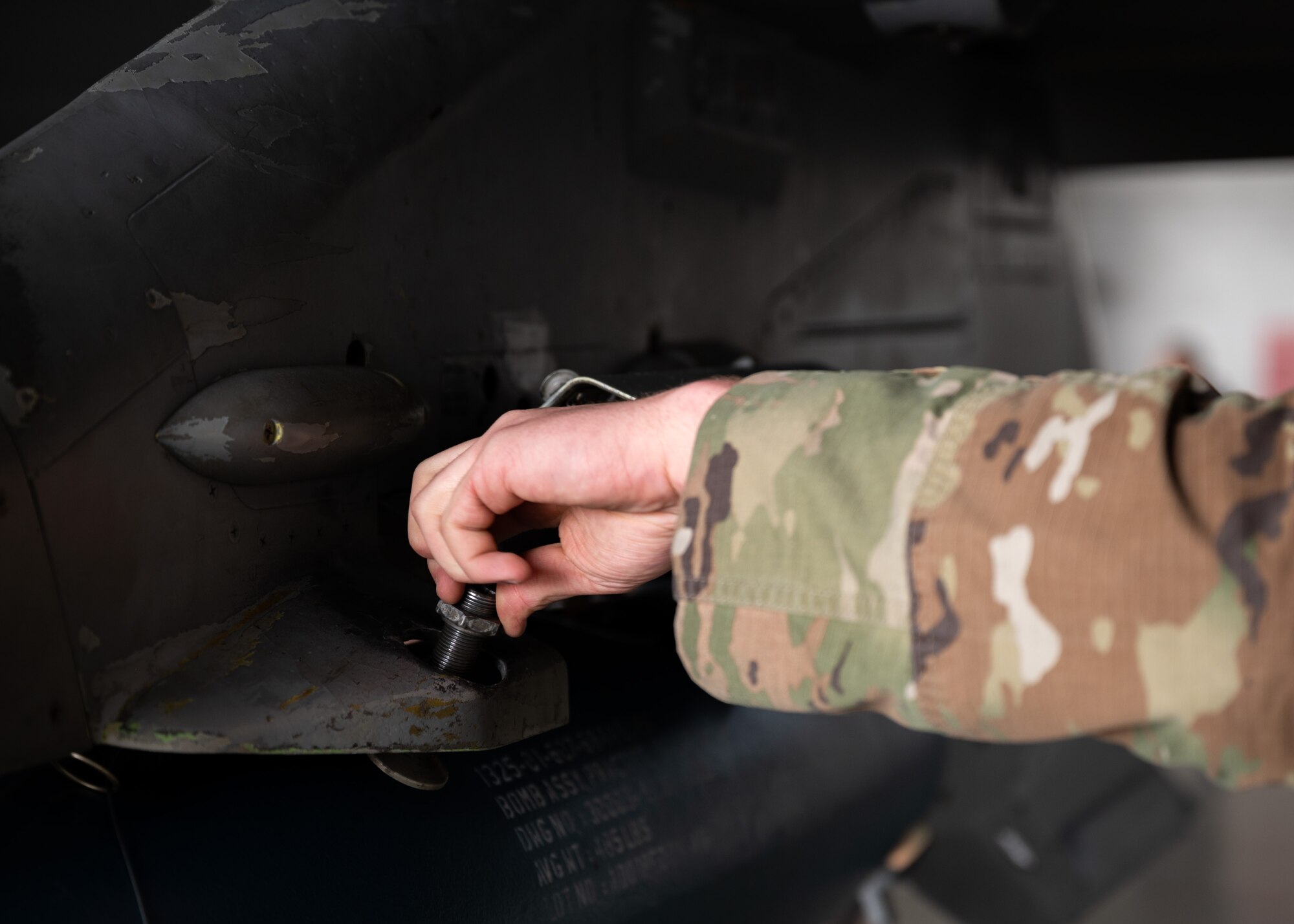 U.S. Air Force Staff Sgt. screws bolt onto F-16C Fighting Falcon panel