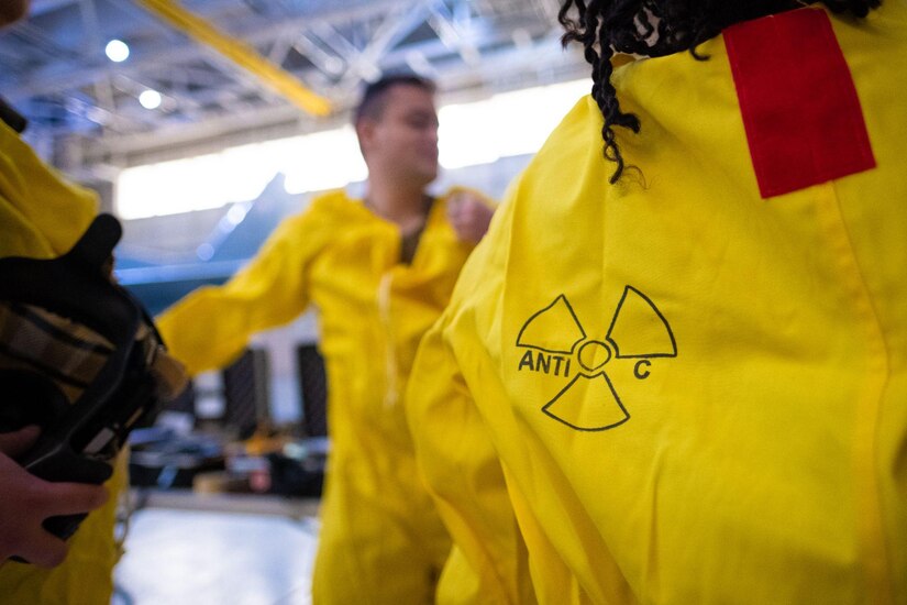 People wear hazmat suits