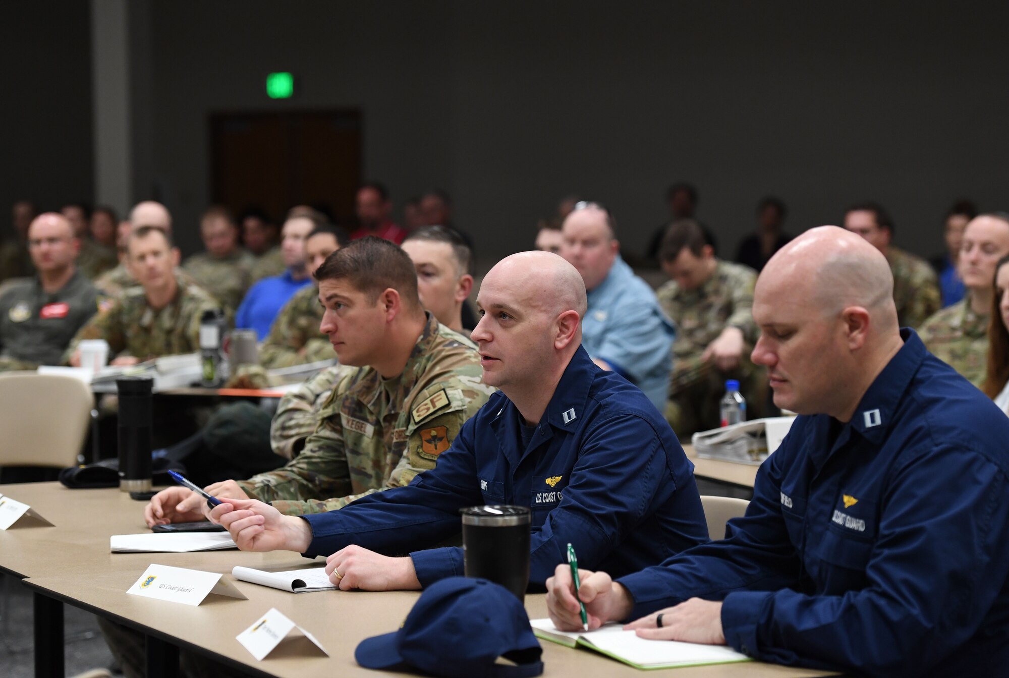U.S. Coast Guard Lt. Joseph Neff, District 8 command deputy officer, New Orleans, La., makes remarks during a joint table top exercise inside the Roberts Consolidated Aircraft Maintenance Facility at Keesler Air Force Base, Mississippi, Feb. 16, 2023.