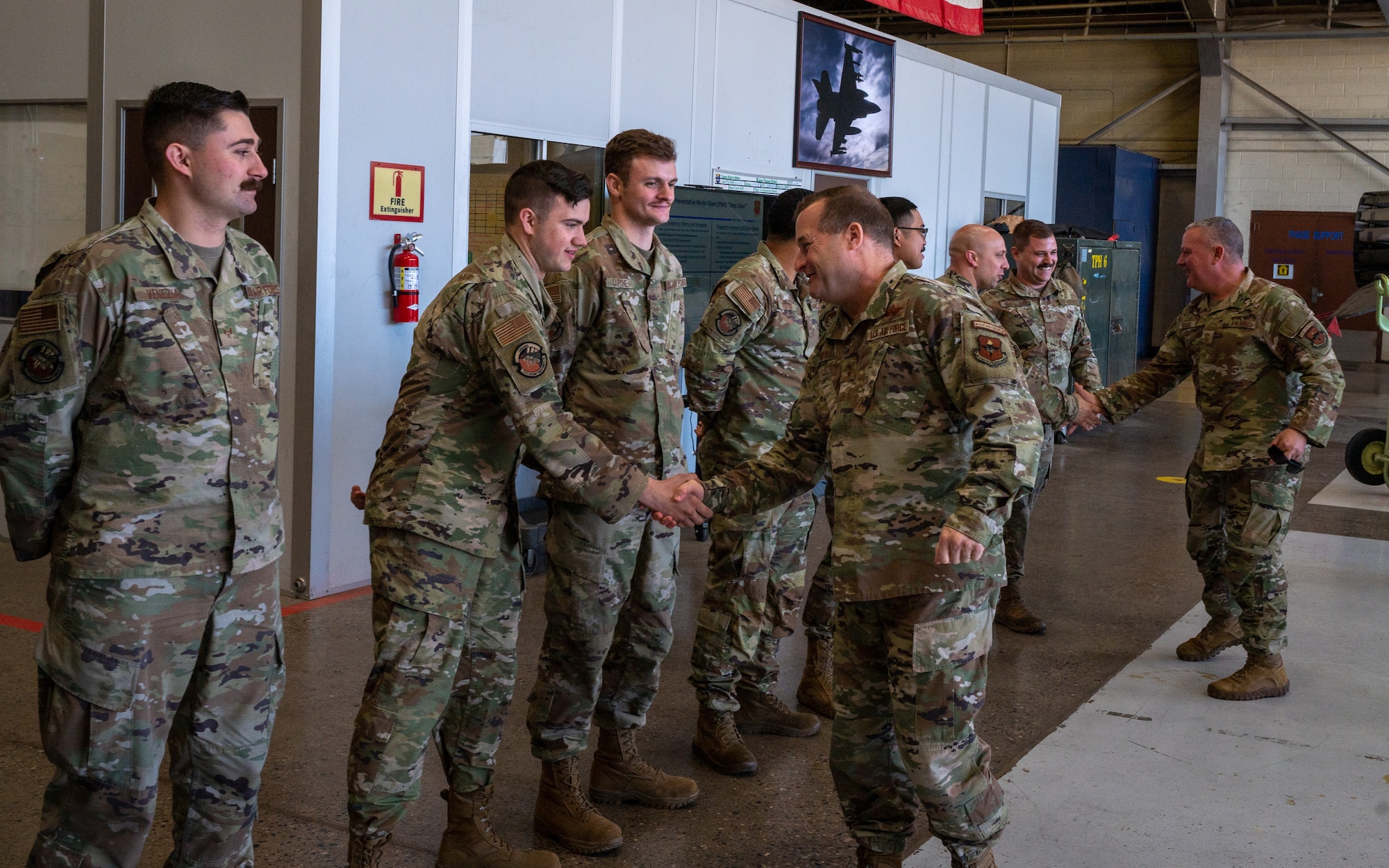 Maj. Gen. Phillip Stewart, 19th Air Force commander (center), and Chief Master Sgt. Justin Apticar, 19th Air Force command chief (far right), engage with Airmen at Luke Air Force Base, Arizona, Feb. 15, 2023.