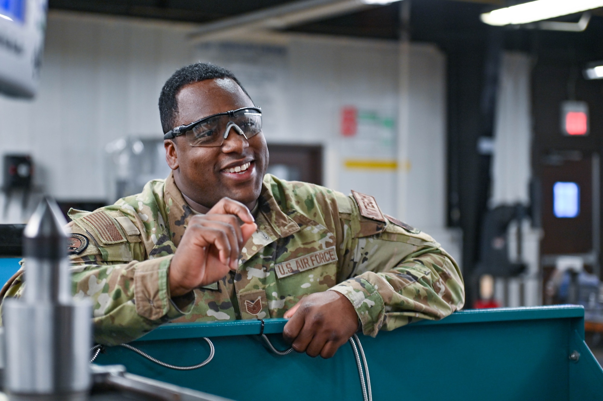 U.S. Air Force Tech. Sgt. Earl Clark, 23rd Maintenance Squadron fabrication flight metals technology section chief, discusses metals equipment techniques with an Airman at Moody Air Force Base, Georgia, Dec. 19, 2022. Non-commissioned officers and experienced Airmen pass down their knowledge to newer Airmen in training. (U.S. Air Force photo by Senior Airman Rebeckah Medeiros)