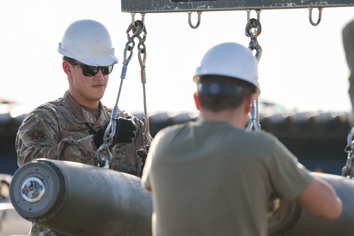 U.S. Air Force Staff Sgt. Cody Heathcock, Air Force Combat Ammunition Center student, assembles a bomb with another Airman as part of Exercise Iron Flag on Feb. 8, 2023, at Beale Air Force Base, Calif.