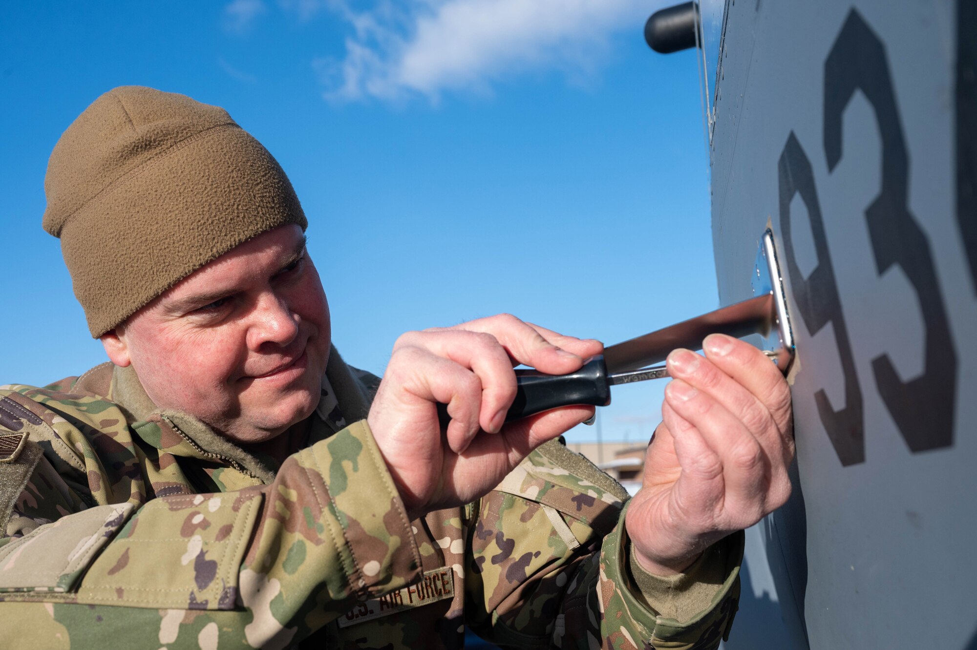 Master Sgt. Luke Huseby, 934th Aircraft Maintenance Squadron instruments and flight control systems technician, screws in an aircraft part on a C-130H at the Minneapolis-St Paul Air Reserve Station, Feb. 2, 2023. (Air Force photo by Senior Airman Colten Tessness)