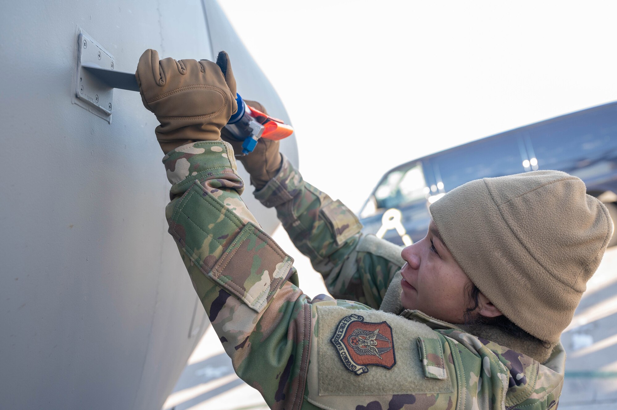 Staff Sgt. Rachelle Beverly, 934th Aircraft Maintenance Squadron instruments and flight control systems technician, installs a Pitot probe to the side of a C-130H at the Minneapolis-Saint Paul Air Reserve Station, Feb. 2, 2023. A Pitot probe is vital for the navigation of the aircraft. (U.S. Air Force photo by Senior Airman Colten Tessness)