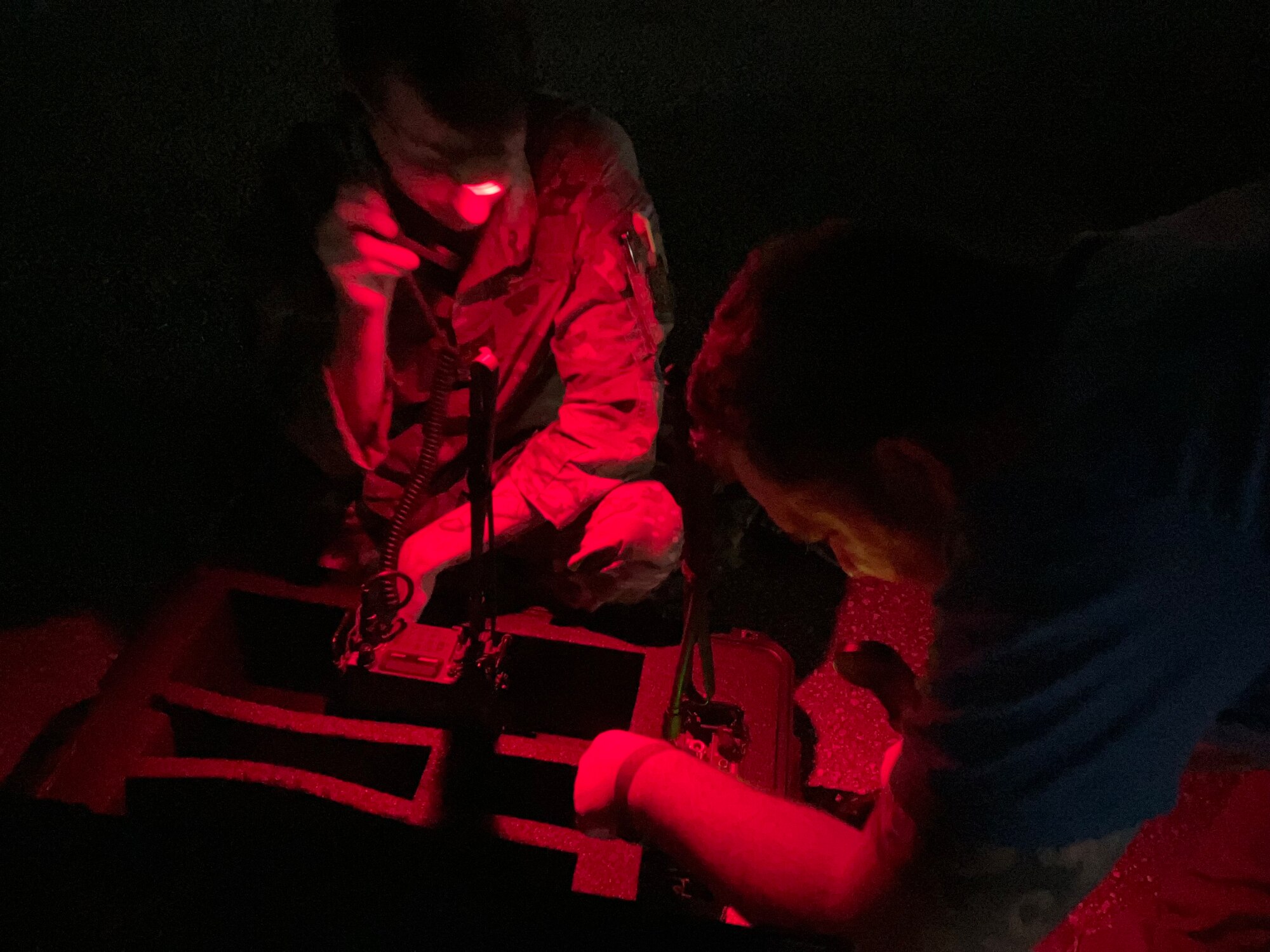 U.S. Air Force Staff Sgt. Luke Merrill, 92nd Operational Support Squadron, and  Maj. Craig Carlson, 92nd Air Refueling Squadron pilot, use radios during the site survey mission, January 2023. (U.S. Air Force courtesy photo)