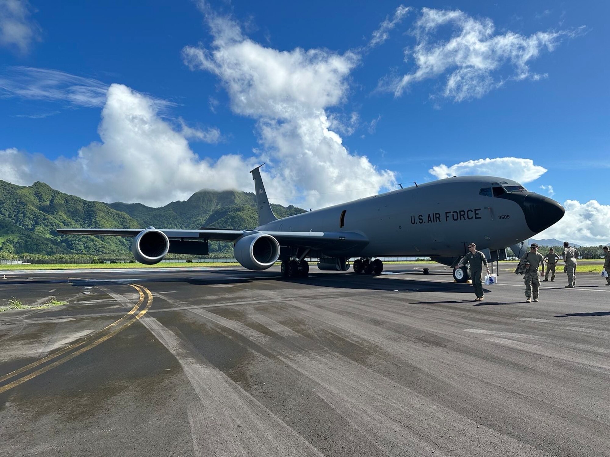 U.S. Air Force Airman walk away from their KC-135 Stratotanker after landing in Pago Pago, American Samoa during a hot-pit site survey mission, January 2023. The primary goal was locating and certifying landing locations suitable for hot-pit refueling. (U.S. Air Force courtesy photo)