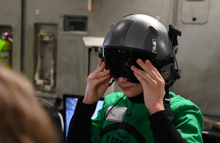 A photo of a student putting on a helmet.