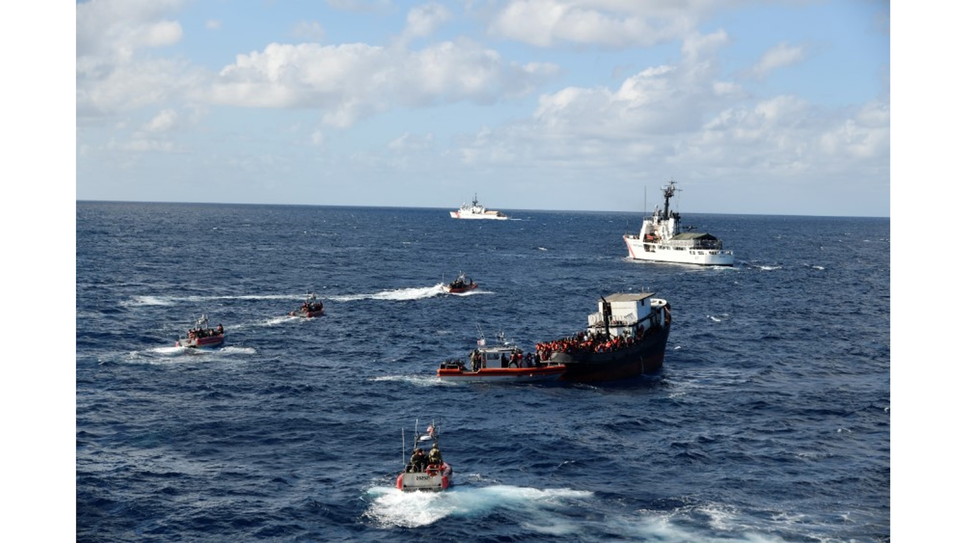 Multiple Coast Guard units stopped the illegal voyage of an overloaded 80-foot motor vessel, 30 miles northeast of Caibarien, Cuba, Feb. 15, 2023. There were over 300 people aboard the Haitian-suspected, migrant voyage vessel. (U.S. Coast Guard photo by Cutter James' crew)