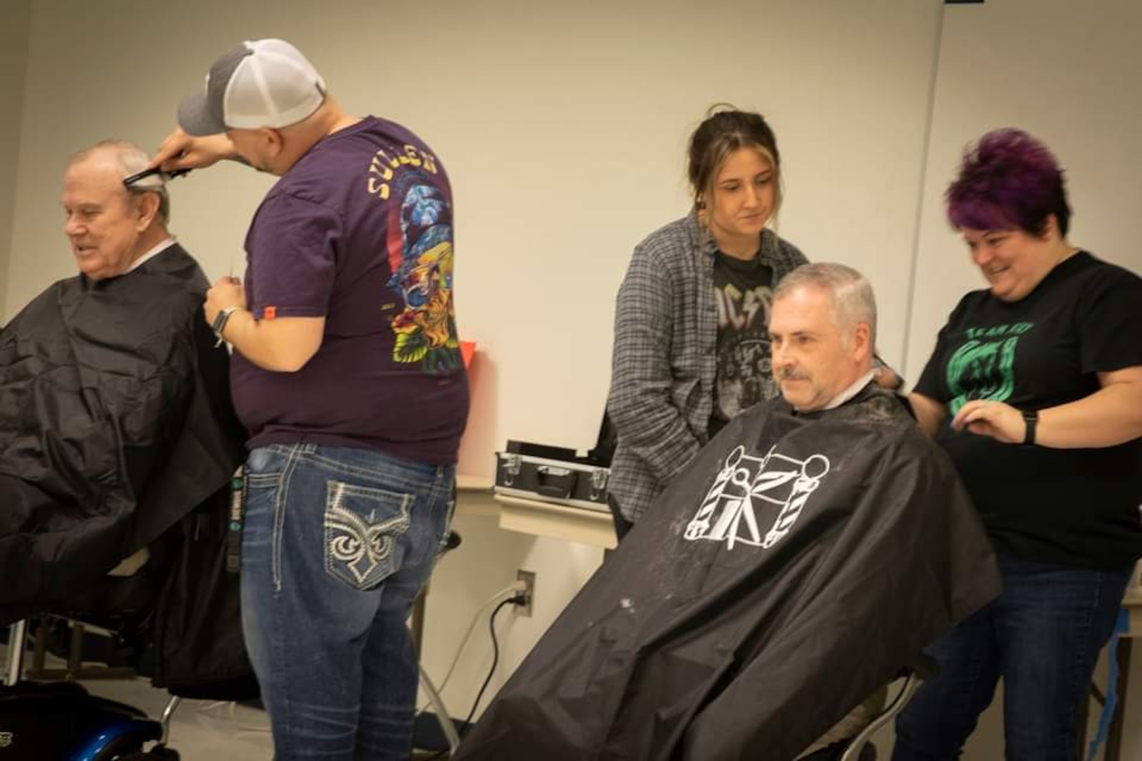 photo of two older white males getting a haircuts