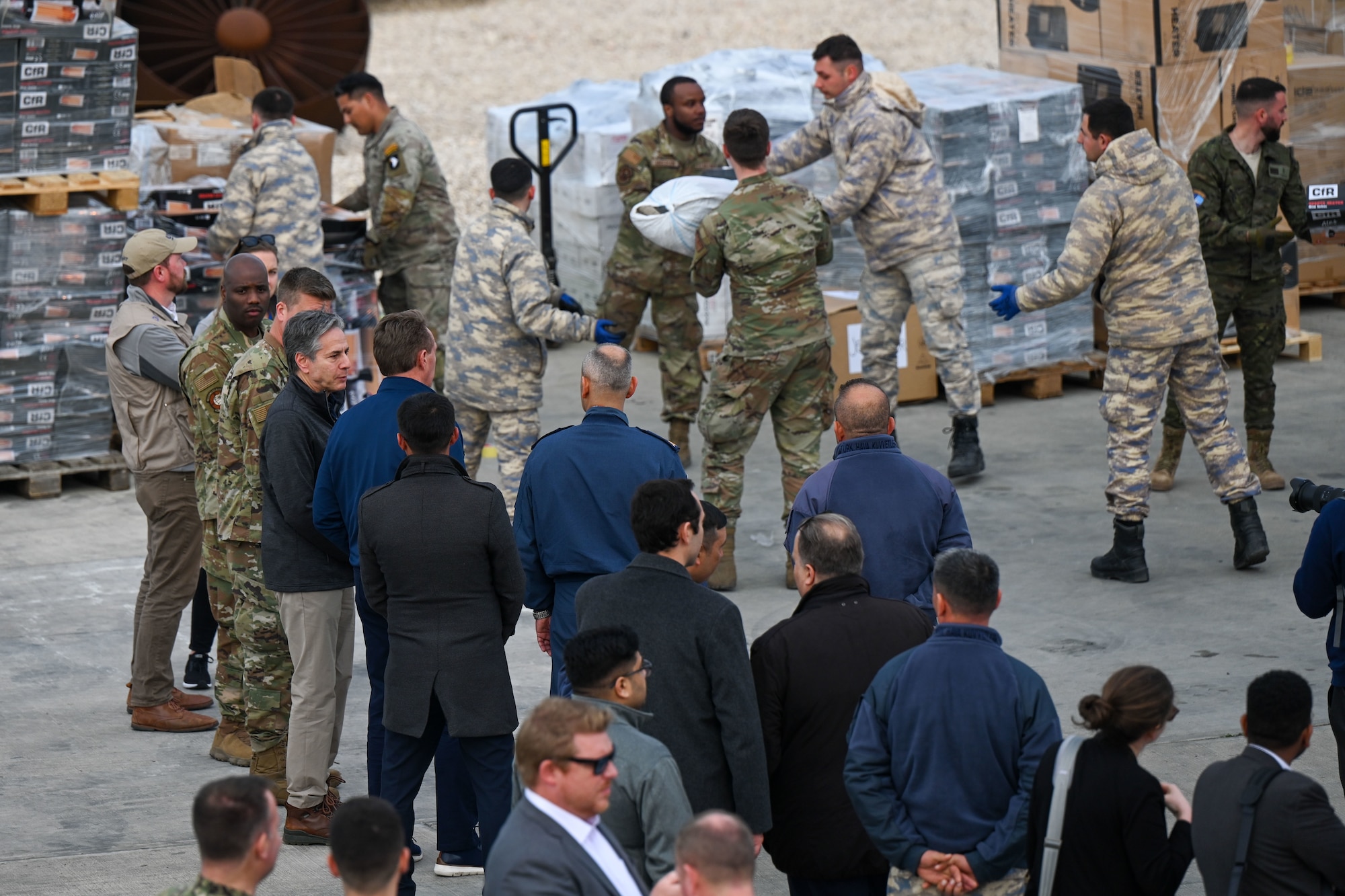 U.S. Secretary of State Antony J. Bliken observes U.S., Spanish and Turkish military members load a truck with humanitarian aid at Incirlik Air Base, Türkiye, Feb. 19, 2023.