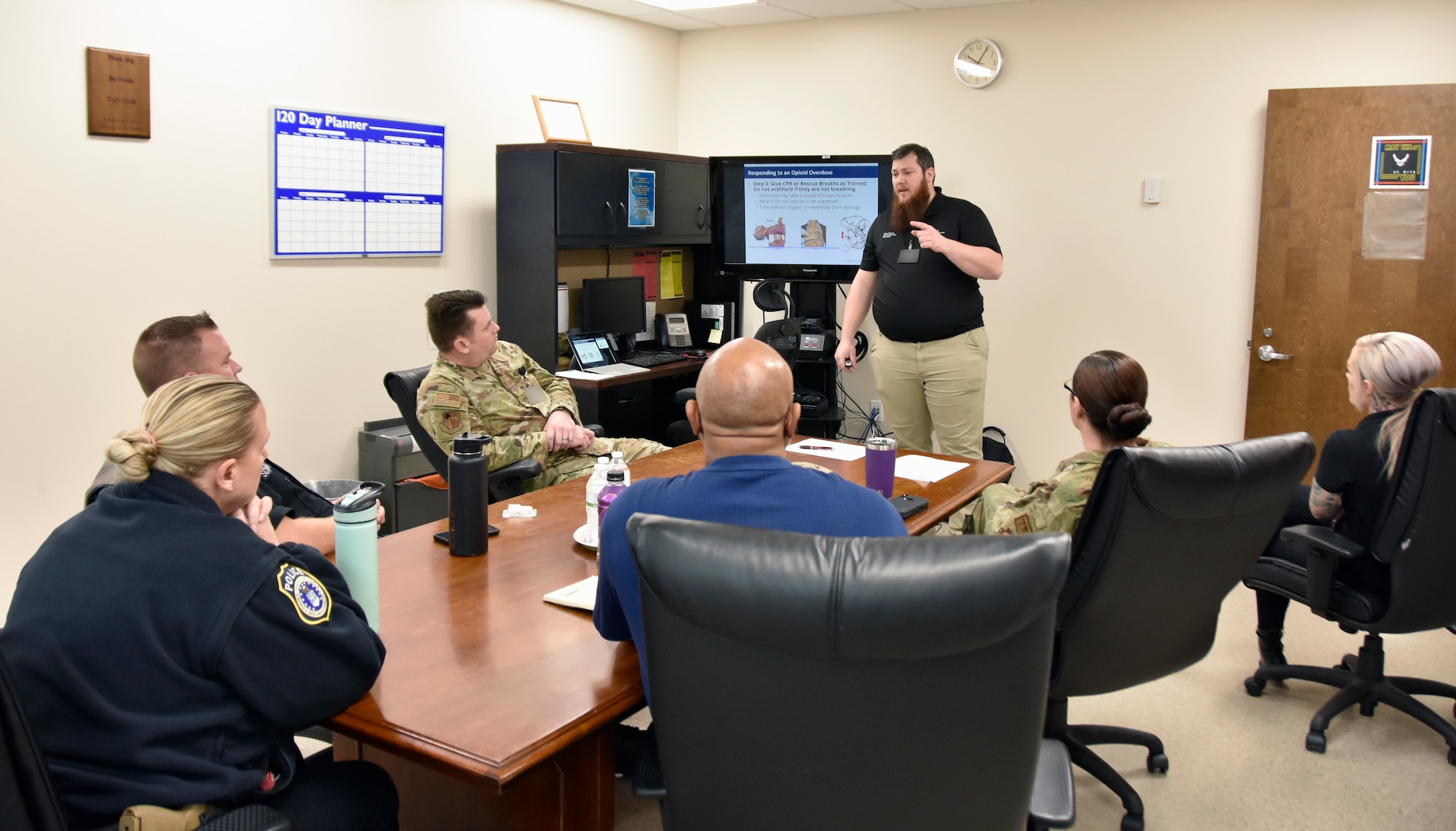 Personnel from several Arnold Air Force Base organizations attend an opioid response training course led by Joshua Crews with the Tennessee First Responder Engagement Specialty Team, standing, and Meredith Hugh with the Franklin County Prevention Coalition, right, Feb. 8, 2023, in the Arnold AFB Medical Aid Station at Arnold AFB, Tennessee. The class was the first of five classes that will be presented for Arnold AFB medical and security forces personnel and other selected individuals and was hosted by the Arnold Engineering Development Complex Commander’s Drug Demand Reduction Program Team. (U.S. Air Force photo by Bradley Hicks) (This image has been altered by obscuring badges for security purposes)