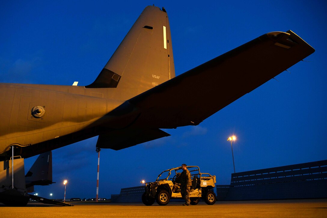 Airmen load vehicles into an aircraft,